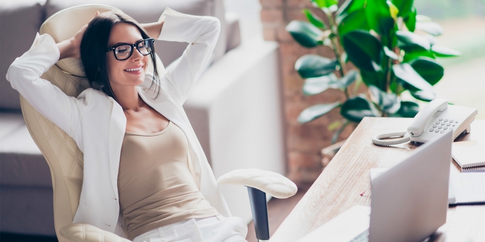 Nice, independent, cute woman in white suit, formal wear, glasses sitting on chair at her desk in office, holding arms behind the head with close eyes, thinking about holidays, vacation